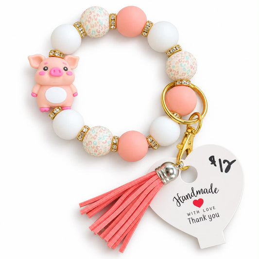 Pink piglet beaded wristlet keychain bracelet with coral tassel